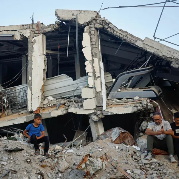 Palestinians attend Eid al-Adha prayers by the ruins of al-Al Rahma mosque destroyed by Israeli air strikes, amid the Israel-Hamas conflict, in Khan Younis, in the southern Gaza Strip, June 16, 2024. REUTERS/Mohammed Salem