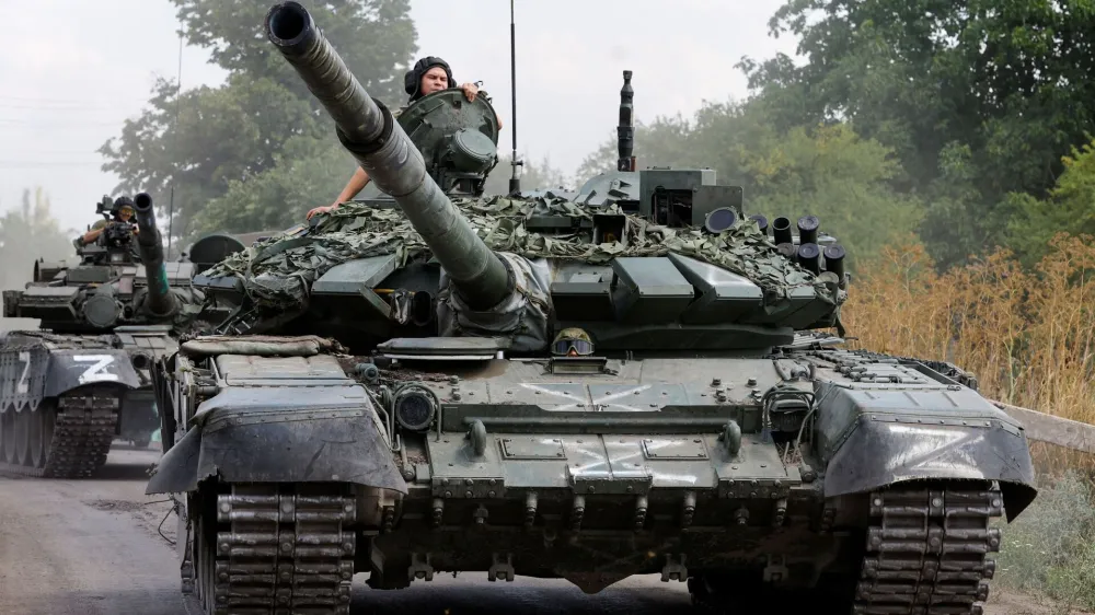 Service members of pro-Russian troops drive tanks in the course of Ukraine-Russia conflict near the settlement of Olenivka in the Donetsk region, Ukraine July 29, 2022. REUTERS/Alexander Ermochenko