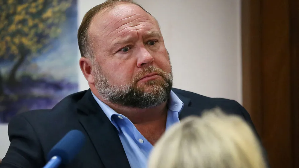 FILE PHOTO: Alex Jones attempts to answer questions about his emails asked by Mark Bankston, lawyer for Neil Heslin and Scarlett Lewis, during trial at the Travis County Courthouse, Austin, Texas, U.S., August 3, 2022. Briana Sanchez/Pool via REUTERS/File Photo