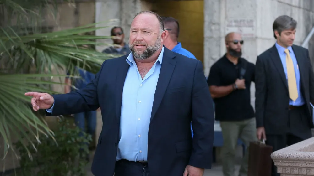 Alex Jones steps outside of the Travis County Courthouse, to do interviews with media after he was questioned under oath about text messages and emails by lawyer Mark Bankston, in Austin, Texas, U.S. August 3, 2022. Briana Sanchez/Pool via REUTERS