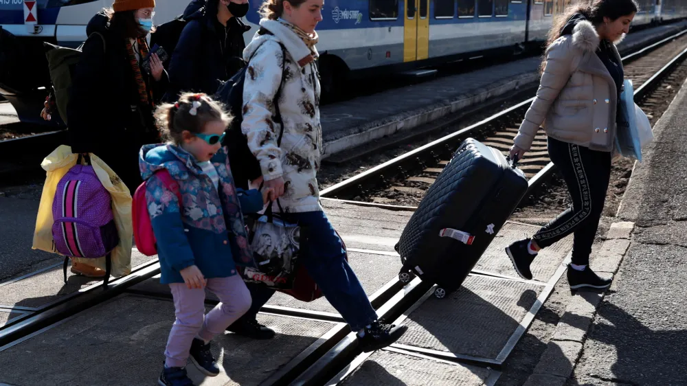 People fleeing from Ukraine to Hungary arrive at the train station, after Russia launched a massive military operation against Ukraine, in Zahony, Hungary, February 27, 2022. REUTERS/Bernadett Szabo