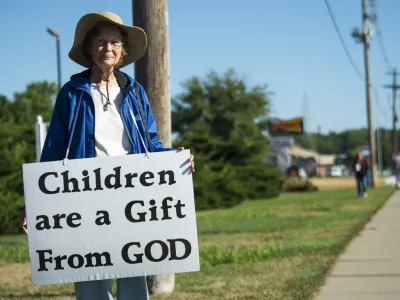 An anti-abortion demonstrator stands outside of the Planned Parenthood Clinic for morning prayers on Tuesday, Aug. 9, 2022, in Lincoln, Neb. (Kenneth Ferreira/Lincoln Journal Star via AP)