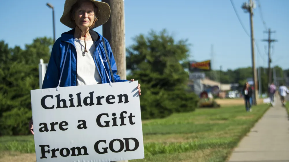 An anti-abortion demonstrator stands outside of the Planned Parenthood Clinic for morning prayers on Tuesday, Aug. 9, 2022, in Lincoln, Neb. (Kenneth Ferreira/Lincoln Journal Star via AP)