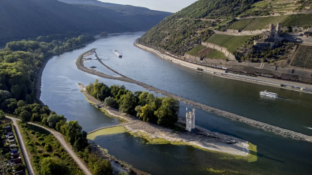 The "Maeuseturm" (mice tower) is pictured in the middle of the river Rhine in Bingen, Germany, Friday, Aug. 12, 2022. The Rhine carries low water after a long drought period. (AP Photo/Michael Probst)