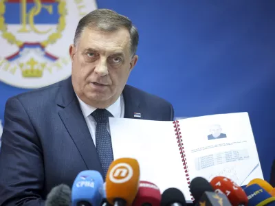 Bosnian Serb political leader Milorad Dodik speaks and shows documents during a press conference in Srebrenica, Bosnia, Thursday, May 23, 2024. Today the United Nations General Assembly will be voting on a draft resolution declaring July 11 the International Day of Reflection and Commemoration of the 1995 genocide in Srebrenica. (AP Photo/Armin Durgut)