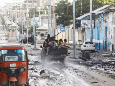 FILE PHOTO: Somali security officers drive past a section of Hotel Hayat, the scene of an al Qaeda-linked al Shabaab group militant attack in Mogadishu, Somalia August 20, 2022. REUTERS/Feisal Omar/File Photo