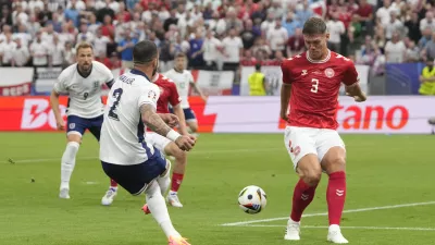 England's Kyle Walker passes the ball to assist for the opening goal during a Group C match between Denmark and England at the Euro 2024 soccer tournament in Frankfurt, Germany, Thursday, June 20, 2024. (AP Photo/Thanassis Stavrakis)