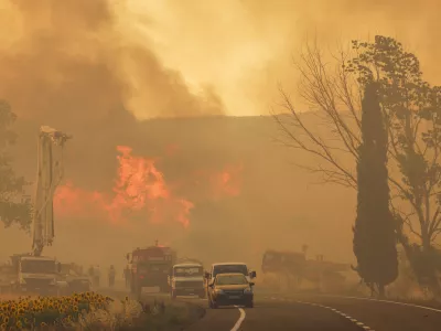 Firefighters work to extinguish a fire burning near Kumkoy, in Gallipoli peninsula, Turkey, Tuesday, June 18, 2024. (Sercan Ozkurnazli/Dia Photo via AP)