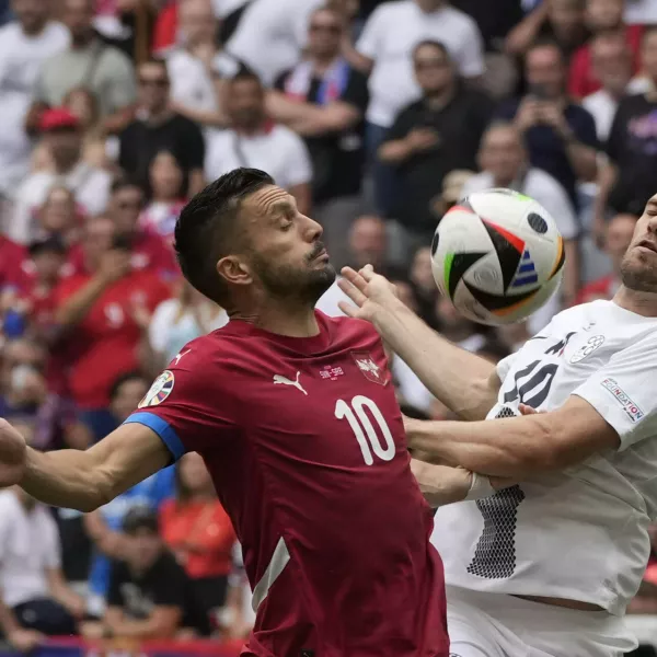 Serbia's Dusan Tadic, left, and Slovenia's Timi Elsnik vie for the ball during a Group C match between Slovenia and Serbia at the Euro 2024 soccer tournament in Munich, Germany, Thursday, June 20, 2024. (AP Photo/Antonio Calanni)