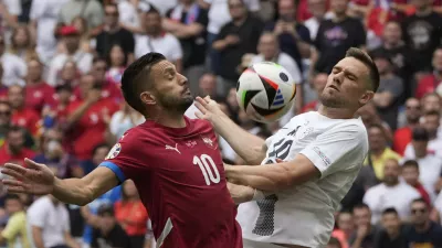 Serbia's Dusan Tadic, left, and Slovenia's Timi Elsnik vie for the ball during a Group C match between Slovenia and Serbia at the Euro 2024 soccer tournament in Munich, Germany, Thursday, June 20, 2024. (AP Photo/Antonio Calanni)