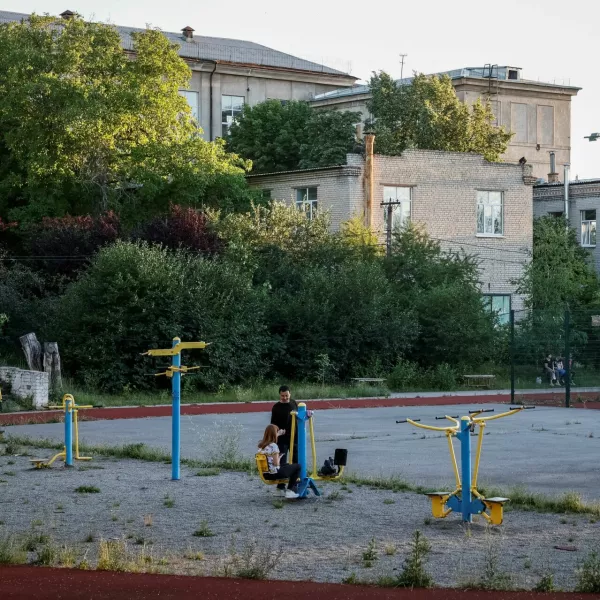 People spend the evening on a playground near a city park, amid Russia's attack on Ukraine, in Kramatorsk, June 21, 2024. REUTERS/Alina Smutko