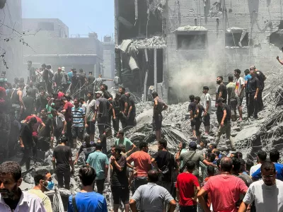 Palestinians search for casualties at the site of Israeli strikes on houses, amid Israel-Hamas conflict, at Al Shati refugee camp in Gaza City, June 22, 2024. REUTERS/Ayman Al Hassi   TPX IMAGES OF THE DAY