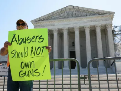 Rev. Patrick Mahoney, director of the Christian Defense Coalition, holds up a sign after U.S. justices rejected a Second Amendment challenge to a federal law that makes it a crime for people subject to domestic violence restraining orders to possess a gun, outside the U.S. Supreme Court in Washington, U.S., June 21, 2024. REUTERS/Amanda Andrade-Rhoades