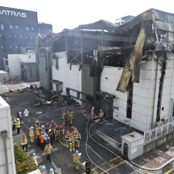 Firefighters carry a body at the site of a fire at a lithium battery manufacturing factory in Hwaseong, South Korea, Monday, June 24, 2024. (Newsis via AP)