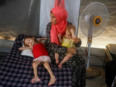 Jana Ayad, a malnourished Palestinian girl, lies on a bed as her mother sits next to her at the International Medical Corps field hospital, amid the Israel-Hamas conflict, in Deir Al-Balah in the southern Gaza Strip, June 22, 2024. REUTERS/Mohammed Salem