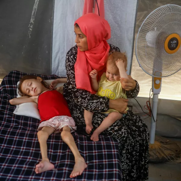 Jana Ayad, a malnourished Palestinian girl, lies on a bed as her mother sits next to her at the International Medical Corps field hospital, amid the Israel-Hamas conflict, in Deir Al-Balah in the southern Gaza Strip, June 22, 2024. REUTERS/Mohammed Salem