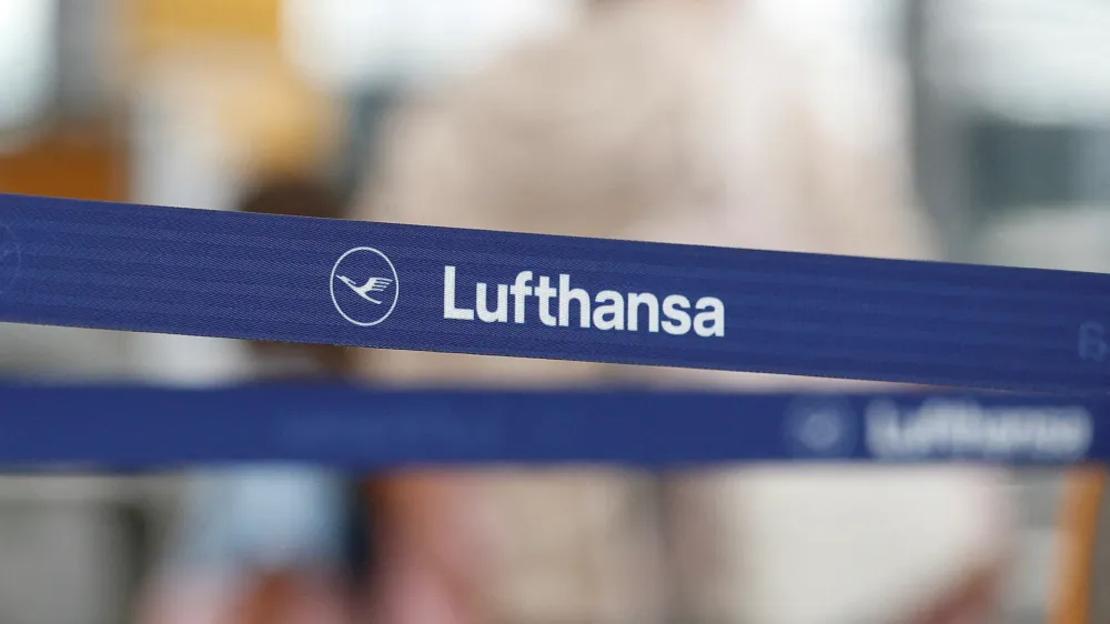 FILE PHOTO: Logo of Lufthansa is seen as passengers wait at Munich Airport during a warning strike staged by Lufthansa ground staff over 9.5 % pay claim by Germany's public sector workers union Verdi in Munich, Germany July 27, 2022. REUTERS/Michaela Rehle//File Photo