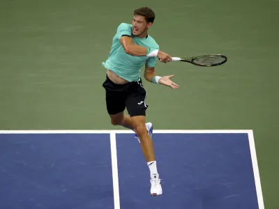 Pablo Carreno Busta, of Spain, returns a shot to Karen Khachanov, of Russia, during the fourth round of the U.S. Open tennis championships, Sunday, Sept. 4, 2022, in New York. (AP Photo/Andres Kudacki)