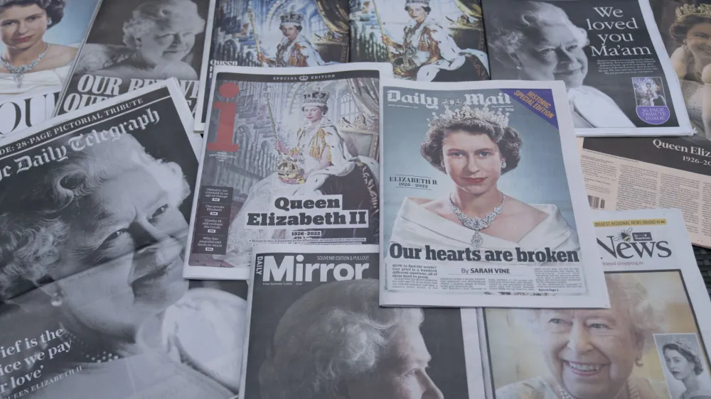 Newspapers devoted to the death of Queen Elizabeth II are seen in Manchester, England, Friday, Sept. 9, 2022. Queen Elizabeth II, Britain's longest-reigning monarch, died on Thursday Sept. 8 aged 96. (AP Photo/Jon Super)