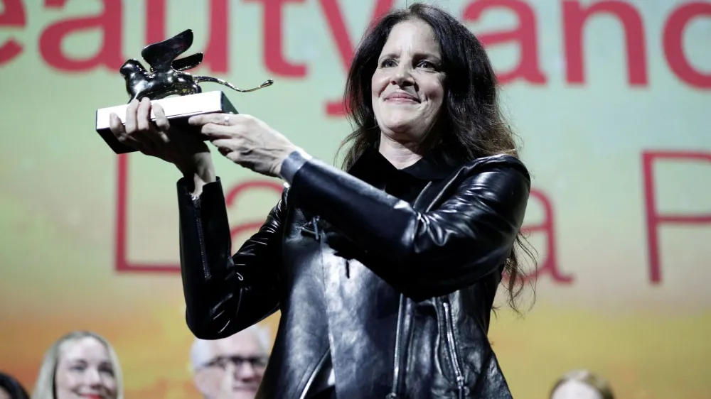 The 79th Venice Film Festival - Awards Ceremony - Venice, Italy, September 10, 2022 - Director Laura Poitras receives the Golden Lion Award for Best Film. REUTERS/Guglielmo Mangiapane