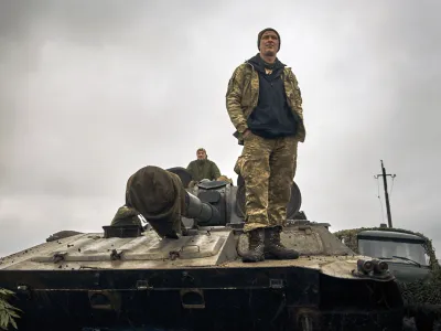 A Ukrainian soldier stands on a tank on the road in the freed territory of the Kharkiv region, Ukraine, Monday, Sept. 12, 2022. Ukrainian troops retook a wide swath of territory from Russia on Monday, pushing all the way back to the northeastern border in some places, and claimed to have captured many Russian soldiers as part of a lightning advance that forced Moscow to make a hasty retreat. (AP Photo/Kostiantyn Liberov)