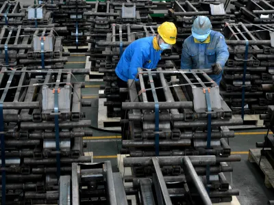 FILE PHOTO: Workers wearing face masks are seen on a production line manufacturing parts for trailers to be exported to the U.S. at a factory, as the country is hit by an outbreak of the novel coronavirus disease (COVID-19), in Taizhou, Jiangsu province, China March 28, 2020. Picture taken March 28, 2020. China Daily via REUTERS ATTENTION EDITORS - THIS IMAGE WAS PROVIDED BY A THIRD PARTY. CHINA OUT./File Photo