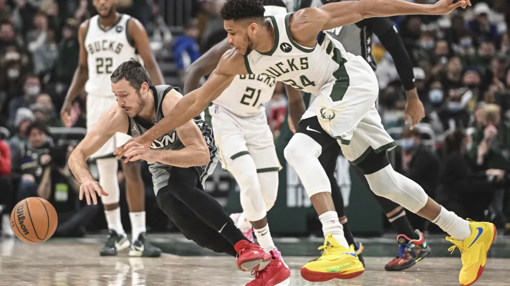 Feb 26, 2022; Milwaukee, Wisconsin, USA; Milwaukee Bucks forward Giannis Antetokounmpo (34) and Brooklyn Nets guard Goran Dragic (9) chase a loose ball in the second quarter at Fiserv Forum. Mandatory Credit: Benny Sieu-USA TODAY Sports