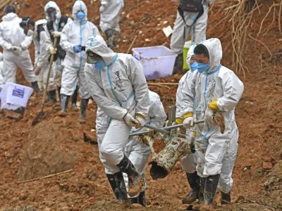 FILE - In this photo released by Xinhua News Agency, rescuers carry a piece of plane wreckage at the site of Monday's plane crash in Tengxian County, southern China's Guangxi Zhuang Autonomous Region, on March 25, 2022. The second "black box" has been recovered following the crash of a China Eastern Boeing 737-800 that killed 132 people last week, Chinese state media said Sunday, March 27. (Zhou Hua/Xinhua via AP, File)