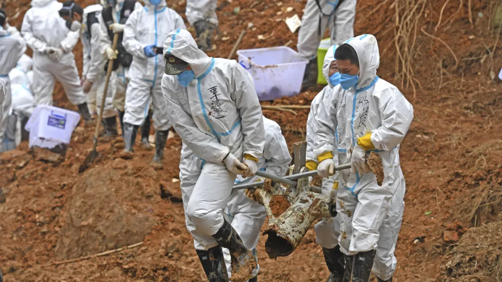 FILE - In this photo released by Xinhua News Agency, rescuers carry a piece of plane wreckage at the site of Monday's plane crash in Tengxian County, southern China's Guangxi Zhuang Autonomous Region, on March 25, 2022. The second "black box" has been recovered following the crash of a China Eastern Boeing 737-800 that killed 132 people last week, Chinese state media said Sunday, March 27. (Zhou Hua/Xinhua via AP, File)