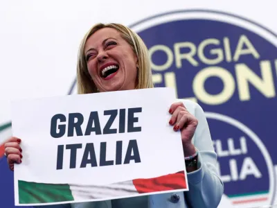 Leader of Brothers of Italy Giorgia Meloni holds a sign at the party's election night headquarters, in Rome, Italy September 26, 2022. REUTERS/Guglielmo Mangiapane   TPX IMAGES OF THE DAY