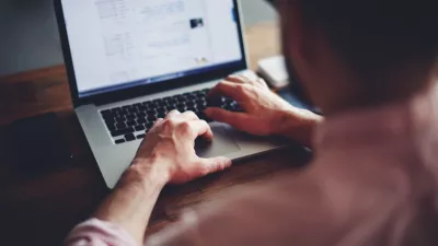 Cropped image of a young man working on his laptop in a coffee shop, rear view of business man hands busy using laptop at office desk, young male student typing on computer sitting at wooden table