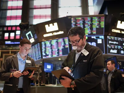 Traders work on the floor at the New York Stock Exchange in New York, Friday, July 1, 2022. Stocks are off to a weak start on Friday, continuing a dismal streak that pushed Wall Street into a bear market last month as traders worry that inflation will be tough to beat and that a recession could be on the way as well. (AP Photo/Seth Wenig)