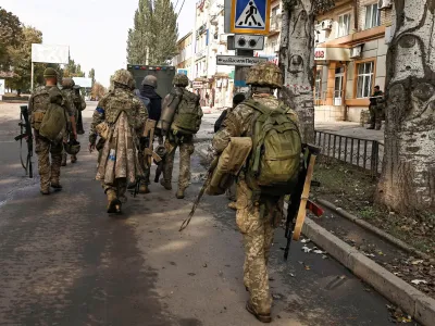 FILE PHOTO: Ukrainian soldiers walk in Bakhmut, amid Russia's attack on Ukraine, in Donetsk region, Ukraine, October 1, 2022. REUTERS/ Zohra Bensemra/File Photo