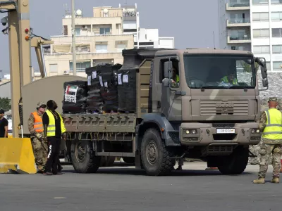 A truck carrying Gaza aid is about to enter a U.S ship, at the port of Larnaca, Cyprus, Wednesday, June 26, 2024. An official with the U.S. humanitarian assistance agency USAID says thousands of tons of food, medicines and other aid piled up on a Gaza beach isn't reaching those in need because of a dire security situation on the ground where truck drivers are either getting caught in the crossfire or have their cargo seized by "gang-like" groups. (AP Photo/Petros Karadjias)