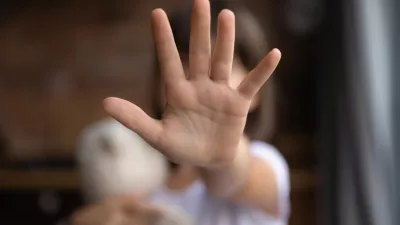 Crop close up of little girl child stretch hand show no gesture protest against domestic violence. Small teen child stand against discrimination or school abuse. Childhood problem, voice concept.