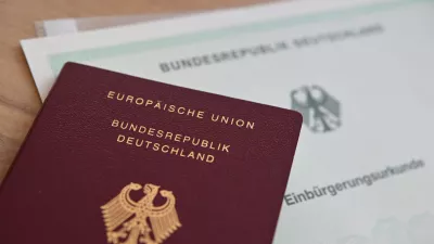 FILED - 24 June 2024, Baden-Wuerttemberg, Stuttgart: A German passport and a naturalization certificate lie on a table. Photo: Marijan Murat/dpa