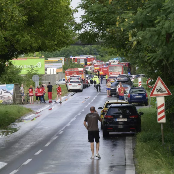 Firefighters vehicles and emergency vehicles on the site of the collision of a bus with a train near the town of Nove Zamky, Slovakia, Thursday, June 27, 2024. Officials in Slovakia says that a train traveling from the Czech capital of Prague to the Hungarian capital of Budapest collided with a bus in southern Slovakia, leaving at least five people dead and five injured. Police and railway officials say that more than 100 people were aboard the Eurocity train when the accident took place shortly after 5 p.m. (1500 GMT) in the town of Nove Zamky. (Henrich Misovic/TASR via AP)