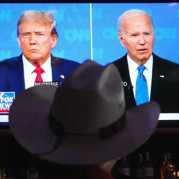 Roger Strassburg, of Scottsdale, Ariz., wears a cowboy hat as he watches the presidential debate between President Joe Biden and Republican presidential candidate former President Donald Trump at a debate watch party Thursday, June 27, 2024, in Scottsdale, Ariz. (AP Photo/Ross D. Franklin)