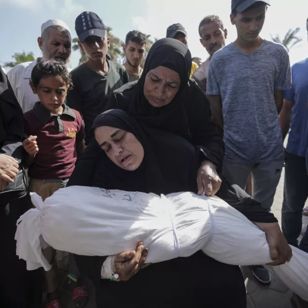 A woman holds the body of her daughter Zena Naser, killed in an Israeli bombardment on a residential building in Maghazi refugee camp, outside the morgue of al-Aqsa Martyrs Hospital in Deir al Balah, central Gaza Strip, Tuesday, June 25, 2024. (AP Photo/Abdel Kareem Hana)