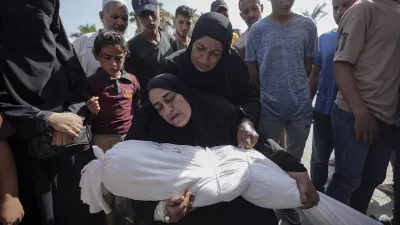 A woman holds the body of her daughter Zena Naser, killed in an Israeli bombardment on a residential building in Maghazi refugee camp, outside the morgue of al-Aqsa Martyrs Hospital in Deir al Balah, central Gaza Strip, Tuesday, June 25, 2024. (AP Photo/Abdel Kareem Hana)