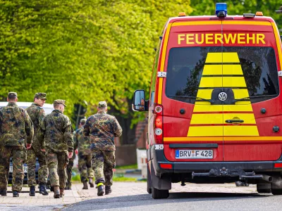 FILED - 27 April 2024, Lower Saxony, Elm: Soldiers of the German Armed Forces walk along a street in a residential area, past a fire department vehicle during the search operation for Arian a missing six-year-old child in northern Lower Saxony. A body found in the German state of Lower Saxony was on 27 June confirmed as that of Arian's, police said.There were no indications of foul play, investigators said. They did not reveal the cause of death to protect the family. Photo: Moritz Frankenberg/dpa