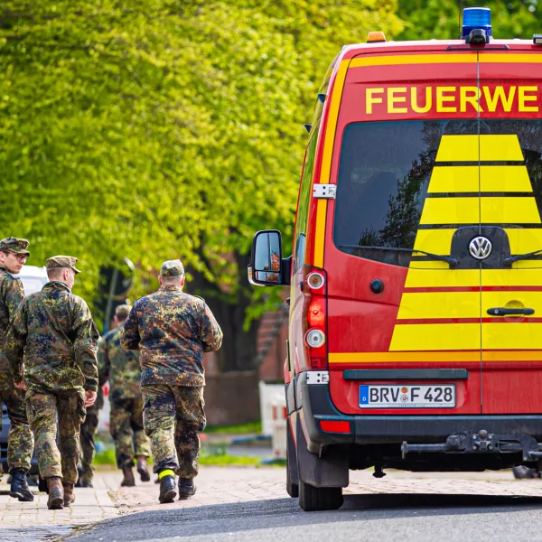 FILED - 27 April 2024, Lower Saxony, Elm: Soldiers of the German Armed Forces walk along a street in a residential area, past a fire department vehicle during the search operation for Arian a missing six-year-old child in northern Lower Saxony. A body found in the German state of Lower Saxony was on 27 June confirmed as that of Arian's, police said.There were no indications of foul play, investigators said. They did not reveal the cause of death to protect the family. Photo: Moritz Frankenberg/dpa