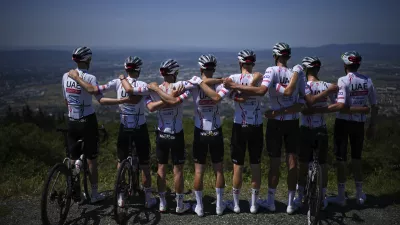 UAE Team Emirates riders with Slovenia's Tadej Pogacar, second left, and Britain's Adam Yates, third left, pose for the team photographer during a training ride near Florence, Italy, Friday, June 28, 2024, one day before the start of the Tour de France cycling race. (AP Photo/Daniel Cole)