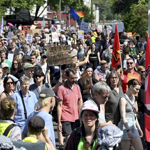 People gather to demonstrate against the AfD national party conference in Essen, Germany, Saturday June 29, 2024. The far-right Alternative for Germany party is holding a convention in the western city of Essen and large-scale protests against the party are taking place. (Henning Kaiser/dpa via AP)