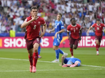 Switzerland's Remo Freuler (8) celebrates after scoring during a round of sixteen match between Switzerland and Italy at the Euro 2024 soccer tournament in Berlin, Germany, Saturday, June 29, 2024. (AP Photo/Matthias Schrader)