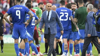 Italy's coach Luciano Spalletti, center, walks between his players after a round of sixteen match between Switzerland and Italy at the Euro 2024 soccer tournament in Berlin, Germany, Saturday, June 29, 2024. (Robert Michael/dpa via AP)