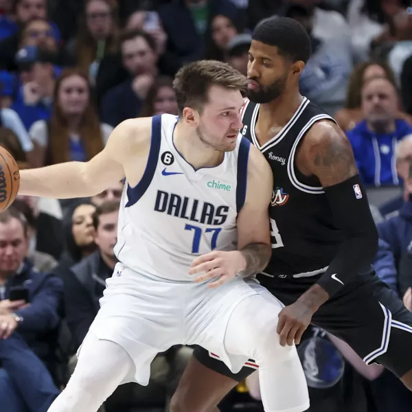 Nov 15, 2022; Dallas, Texas, USA; Dallas Mavericks guard Luka Doncic (77) controls the ball as LA Clippers guard Paul George (13) defends during the second half at American Airlines Center. Mandatory Credit: Kevin Jairaj-USA TODAY Sports