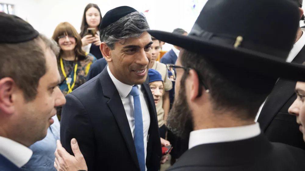 Britain's Prime Minister Rishi Sunak meets locals, during a visit to Machzike Hadath Synagogue, in Golders Green, while on the general election campaign trail, in north west London, Sunday June 30, 2024. (James Manning/Pool Photo via AP)