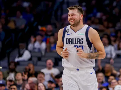 Dallas Mavericks point guard Luka Doncic smiles after making a basket during the first half of a preseason NBA basketball game against the Orlando Magic, Friday, Oct. 7, 2022, in Dallas. (AP Photo/Gareth Patterson)