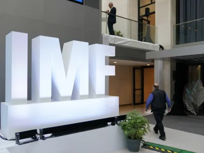 Attendees walk inside an atrium at the 2022 Annual Meetings of the International Monetary Fund and the World Bank Group, Monday, Oct. 10, 2022, in Washington. (AP Photo/Patrick Semansky)